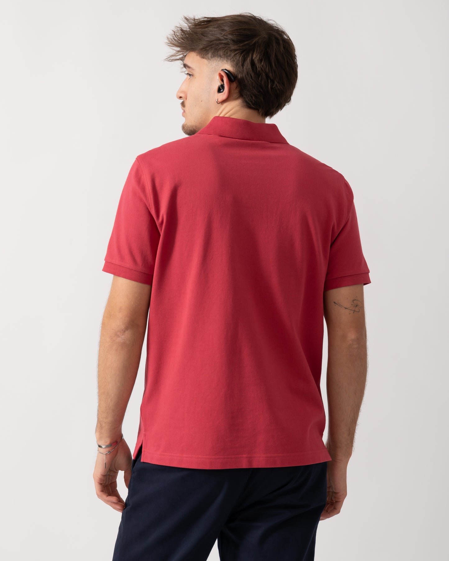 back shot of a Model wearing a GANT Mens Regular Fit Short Sleeve Shield Logo Pique Polo in Muted Red