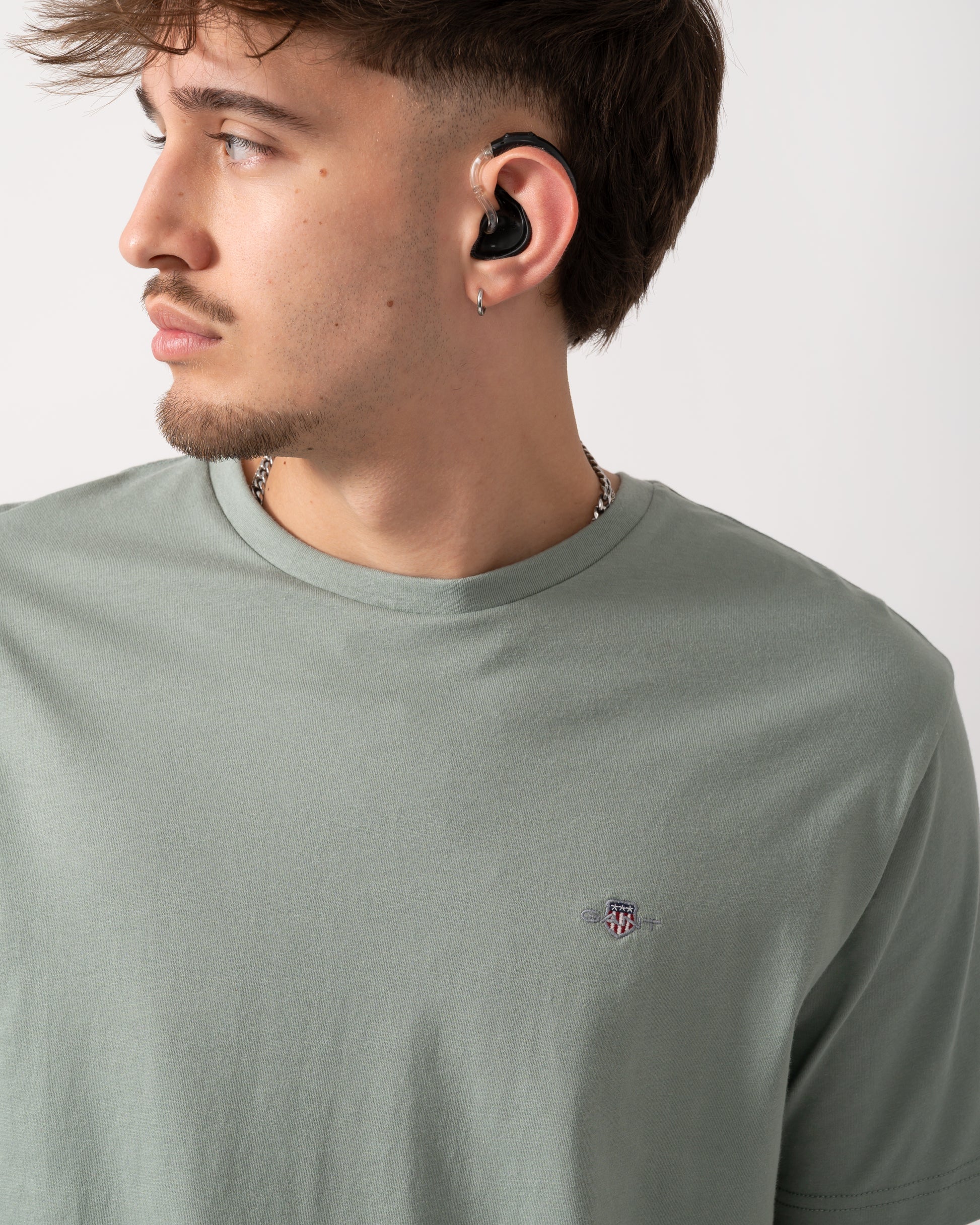 Detail shot of a Model wearing a GANT Mens Regular Fit Short Sleeve Shield Logo T-Shirt in Ceramic Grey