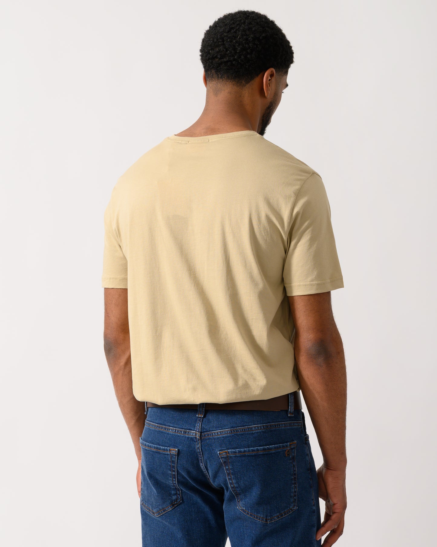 back shot of a model wearing a GANT Mens Regular Fit Short Sleeve Shield Logo T-Shirt in Oat Beige