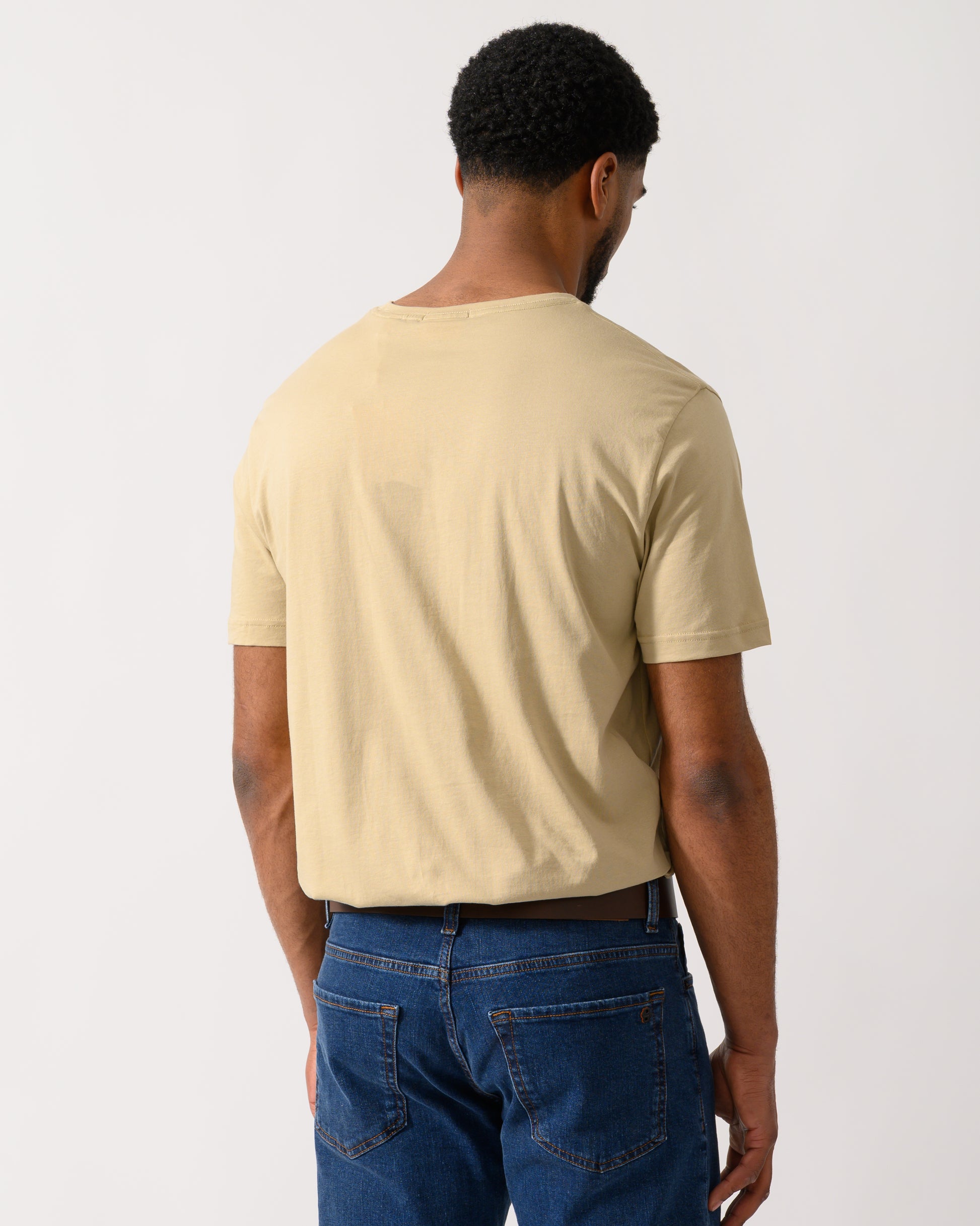 back shot of a model wearing a GANT Mens Regular Fit Short Sleeve Shield Logo T-Shirt in Oat Beige