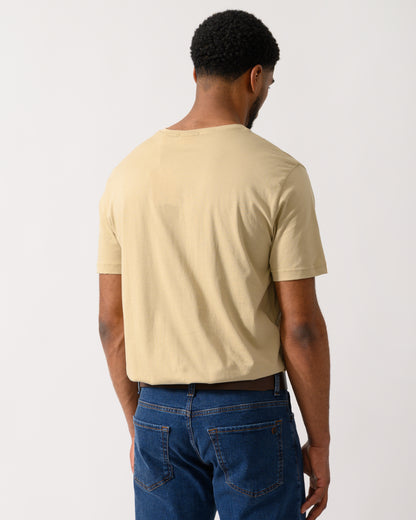 back shot of a model wearing a GANT Mens Regular Fit Short Sleeve Shield Logo T-Shirt in Oat Beige