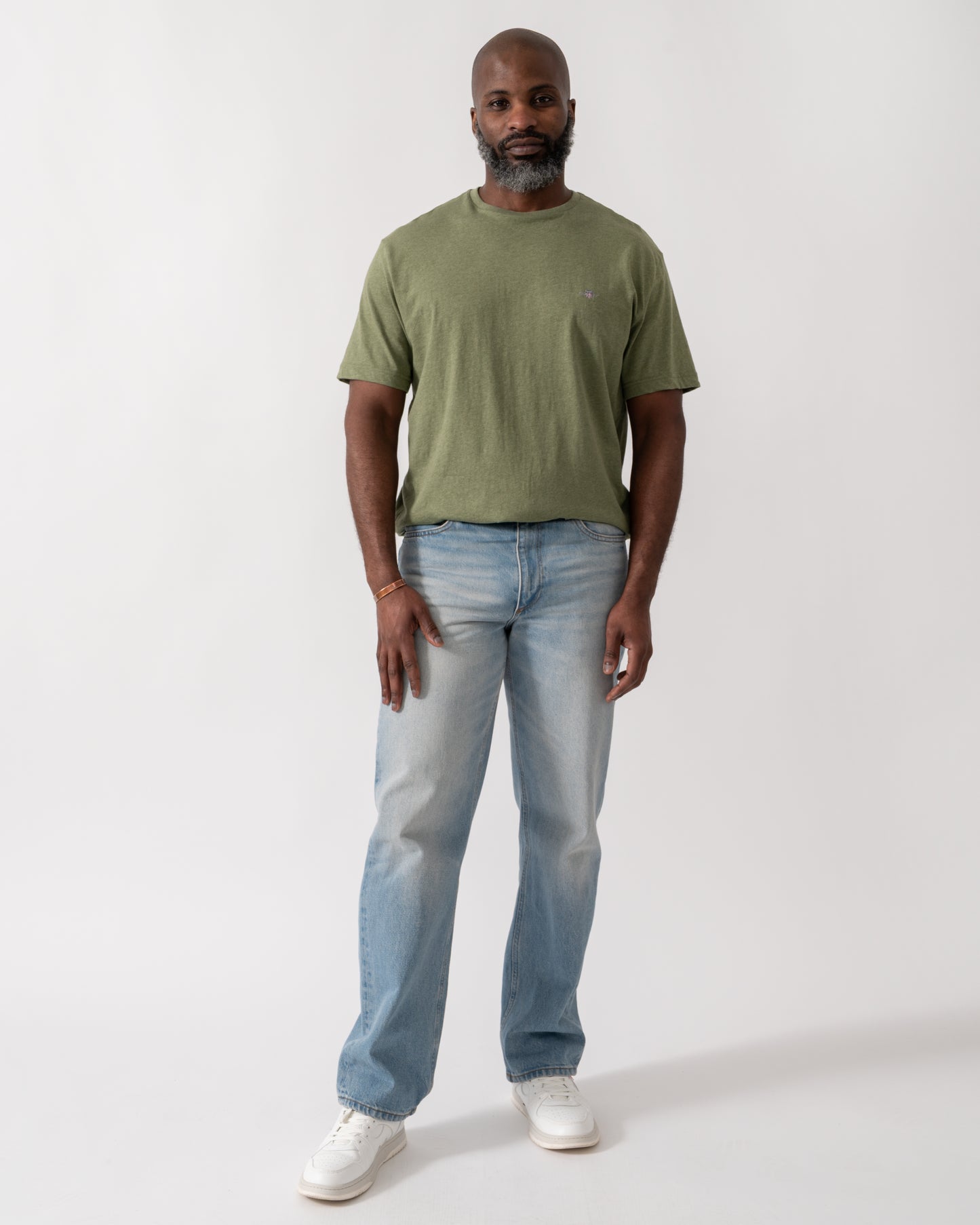 full length shot a a model wearing a GANT Mens Regular Fit Short Sleeve Shield Logo T-Shirt in Dark Cactus Melange