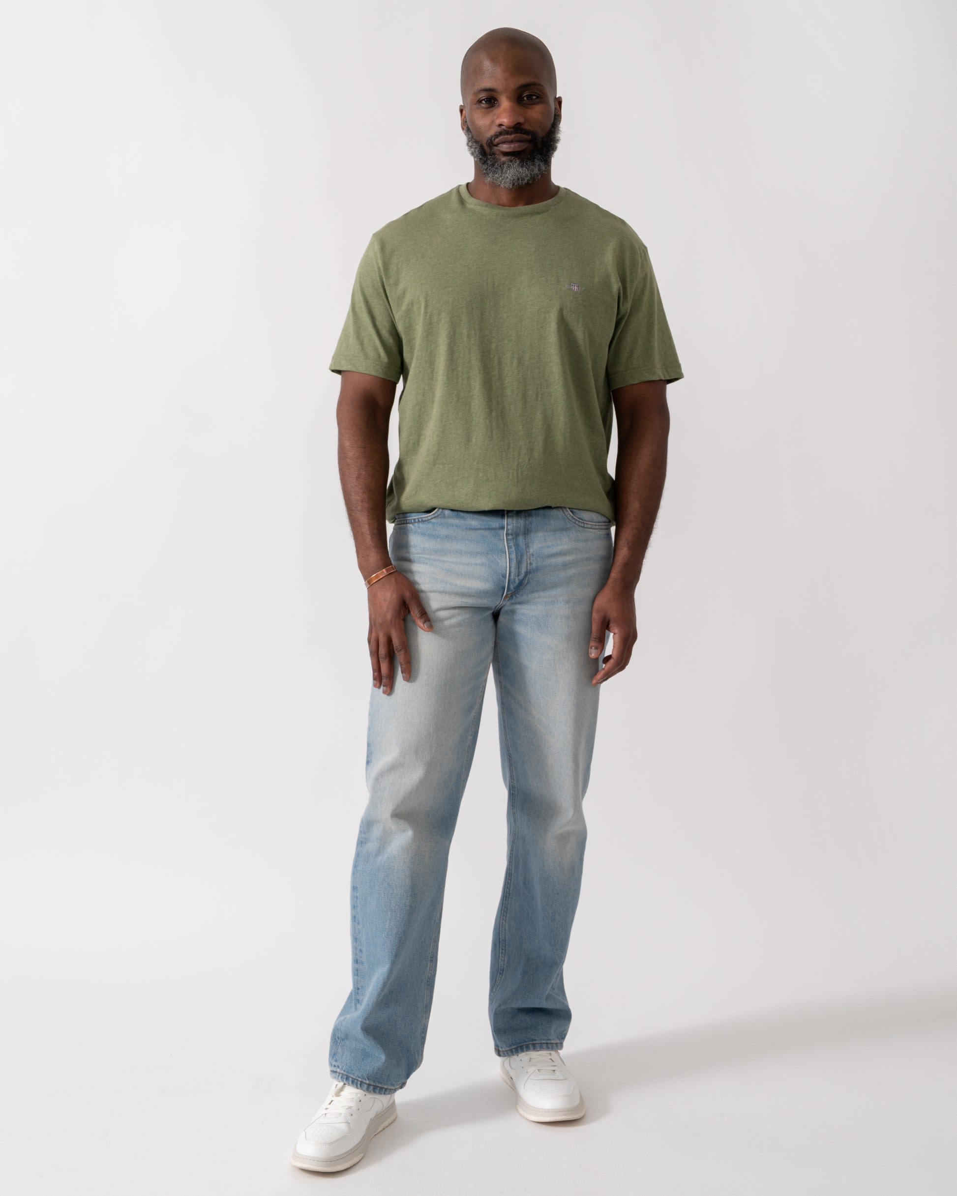 full length shot a a model wearing a GANT Mens Regular Fit Short Sleeve Shield Logo T-Shirt in Dark Cactus Melange