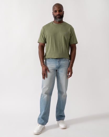 full length shot a a model wearing a GANT Mens Regular Fit Short Sleeve Shield Logo T-Shirt in Dark Cactus Melange