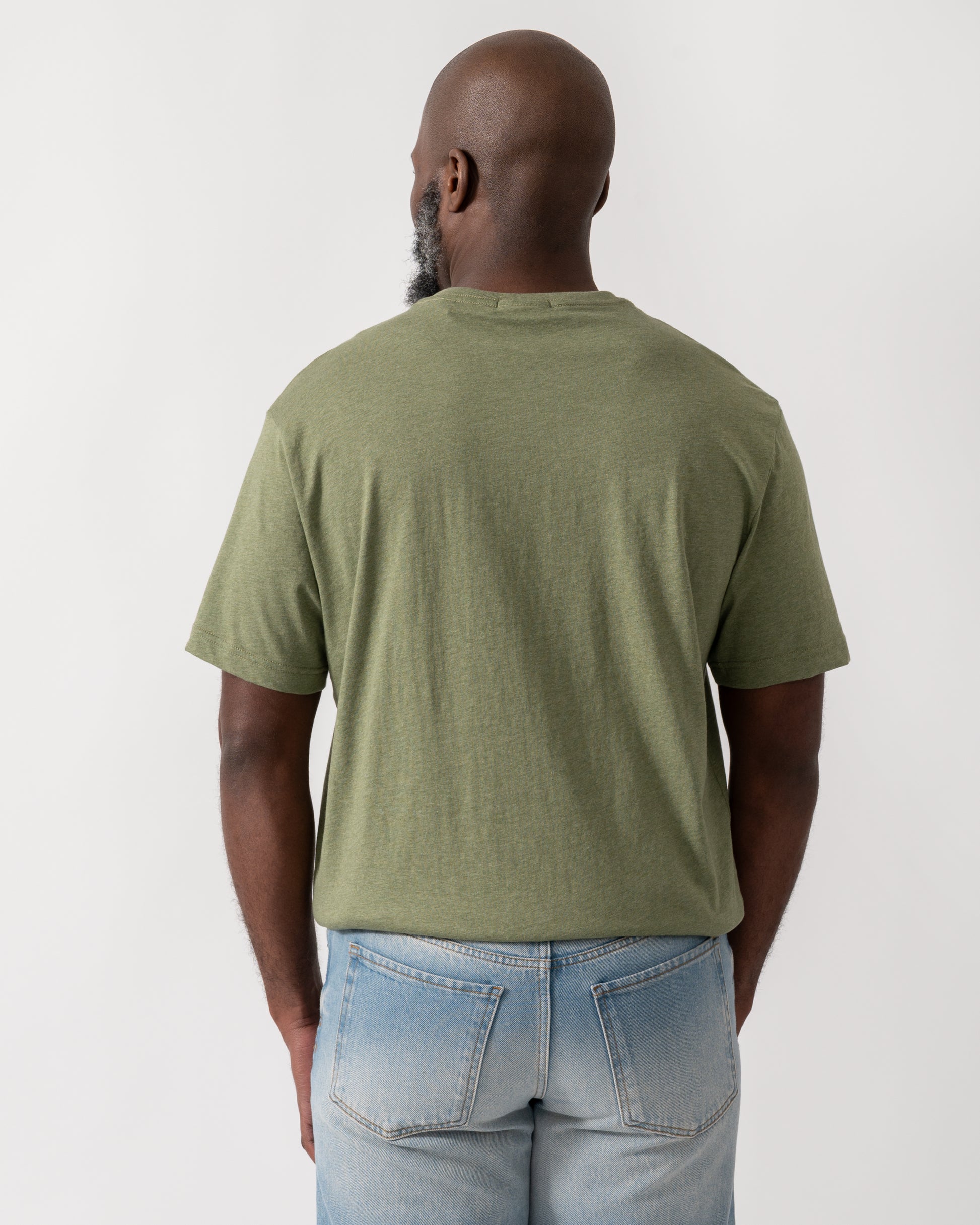 back shot a a model wearing a GANT Mens Regular Fit Short Sleeve Shield Logo T-Shirt in Dark Cactus Melange