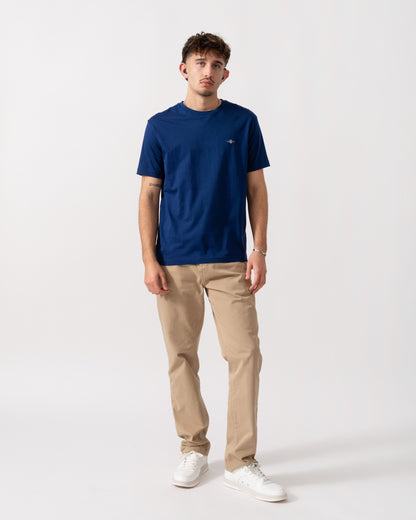 Full length shot of a model wearing a GANT Mens Regular Fit Short Sleeve Shield Logo T-Shirt in Rich Navy