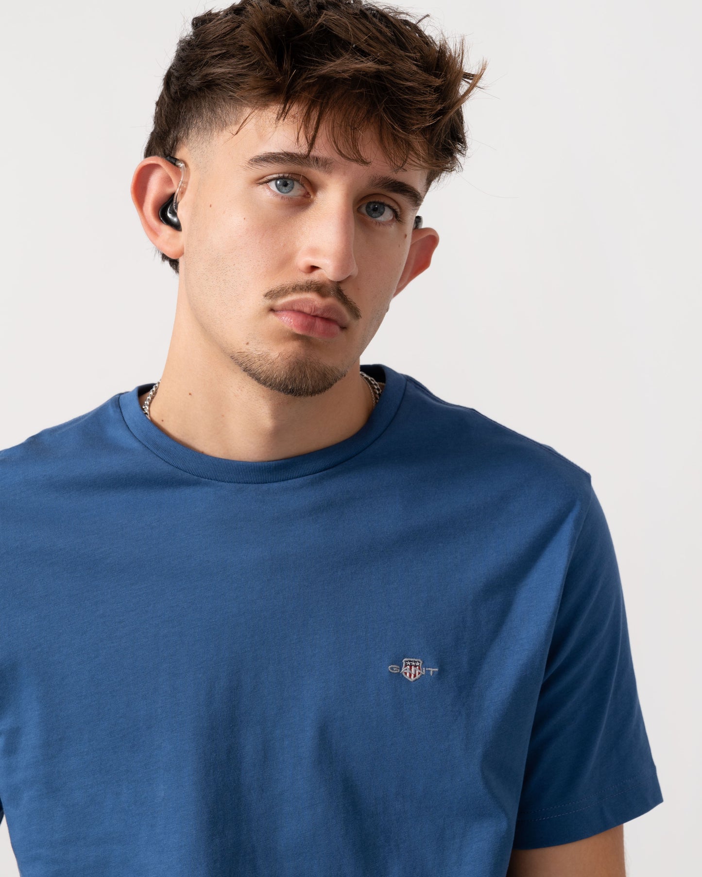 Detail shot of Model wearing a GANT Mens Regular Fit Short Sleeve Shield Logo T-Shirt in Vintage Blue