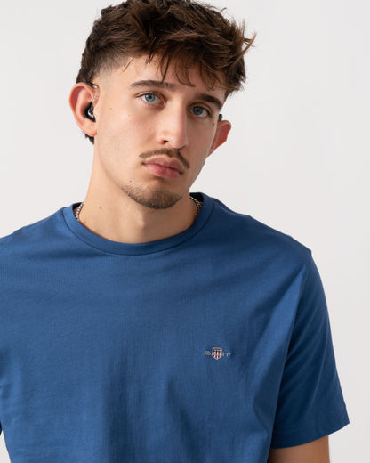 Detail shot of Model wearing a GANT Mens Regular Fit Short Sleeve Shield Logo T-Shirt in Vintage Blue