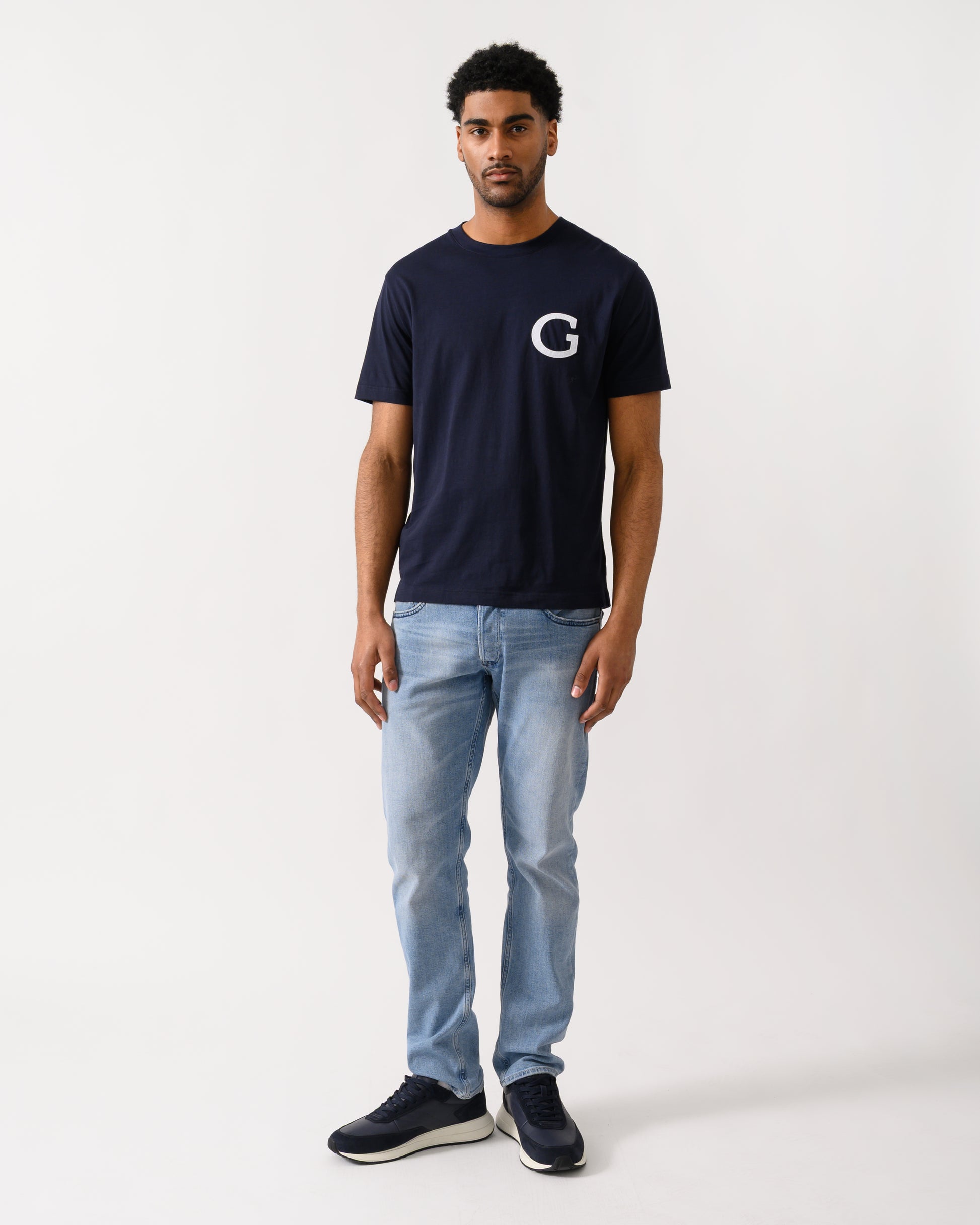 full length shot of aModel wearing a GANT Mens Short Sleeve G-Badge T-Shirt in 433 Evening Blue