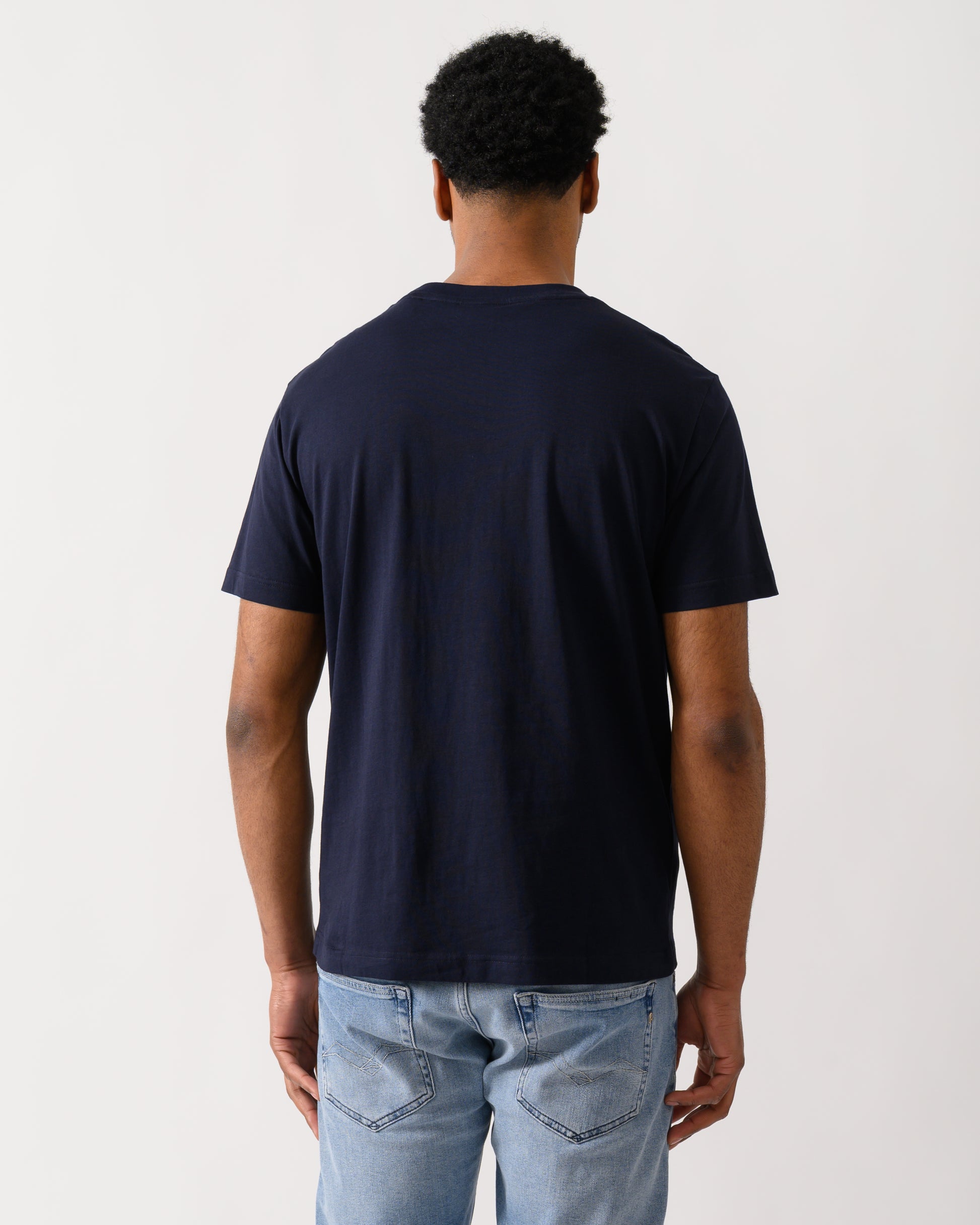 back shot of aModel wearing a GANT Mens Short Sleeve G-Badge T-Shirt in 433 Evening Blue