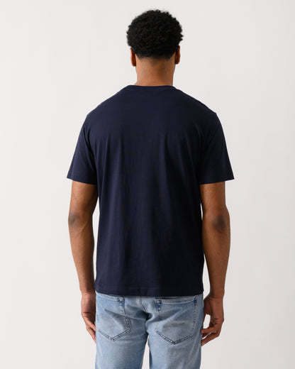 back shot of aModel wearing a GANT Mens Short Sleeve G-Badge T-Shirt in 433 Evening Blue