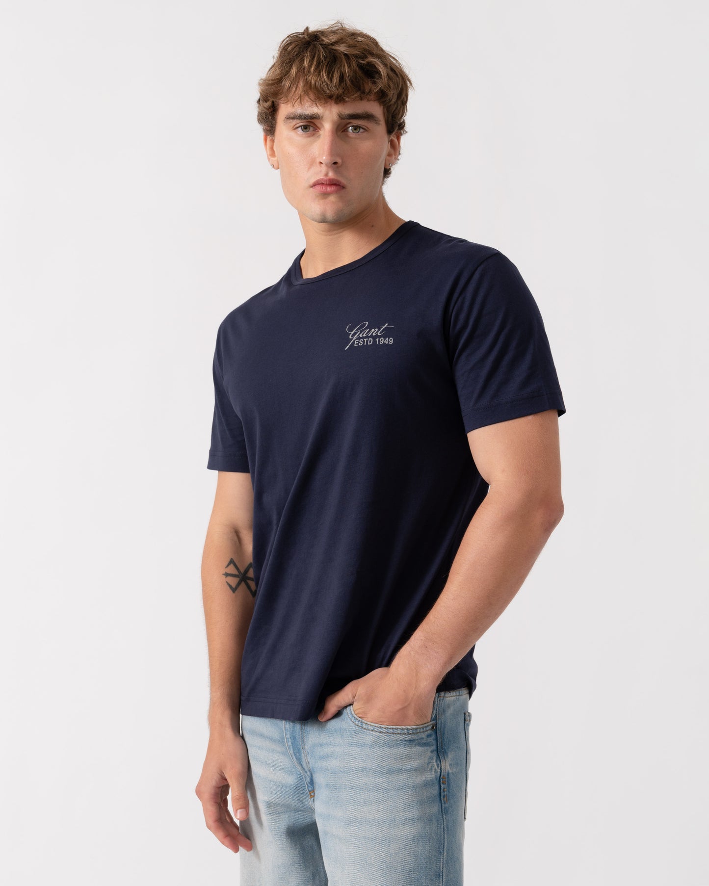 Model wearing GANT Mens Short Sleeve Small Graphic Logo T-Shirt - 433 Evening Blue