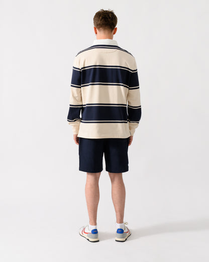 back shot of a model wearing a GANT Mens Striped Rugger in 433 Evening Blue