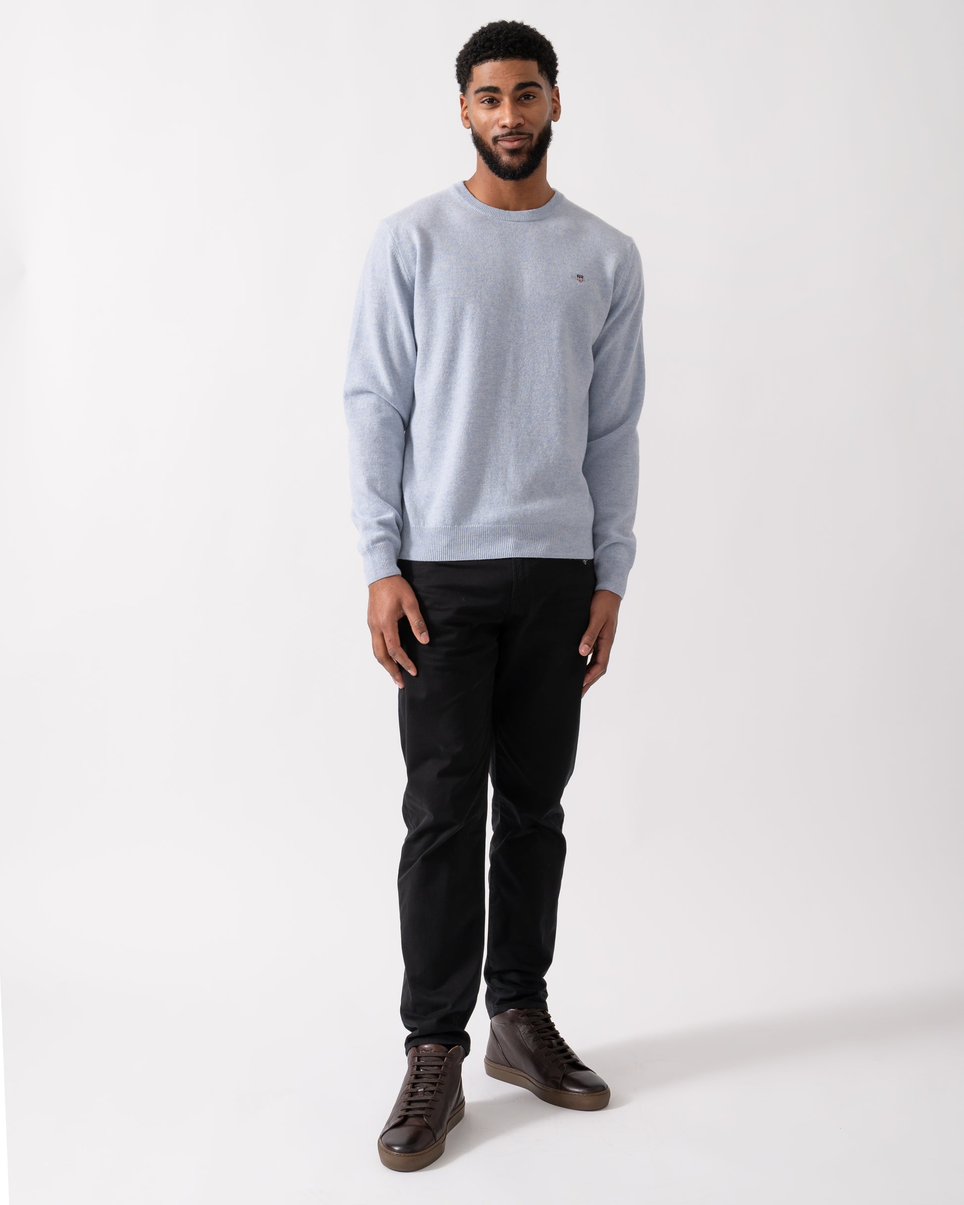 wide shot of a model wearing a GANT Mens Superfine Lambswool Crew Neck Jumper in Ice Blue Melange