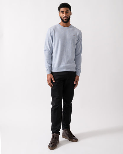 wide shot of a model wearing a GANT Mens Superfine Lambswool Crew Neck Jumper in Ice Blue Melange