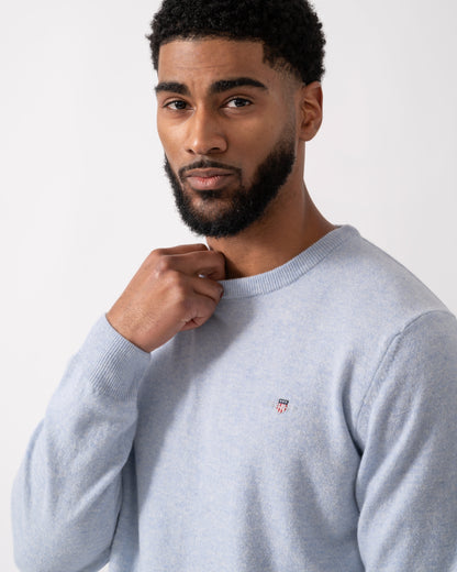 Close up of a model wearing a GANT Mens Superfine Lambswool Crew Neck Jumper in Ice Blue Melange