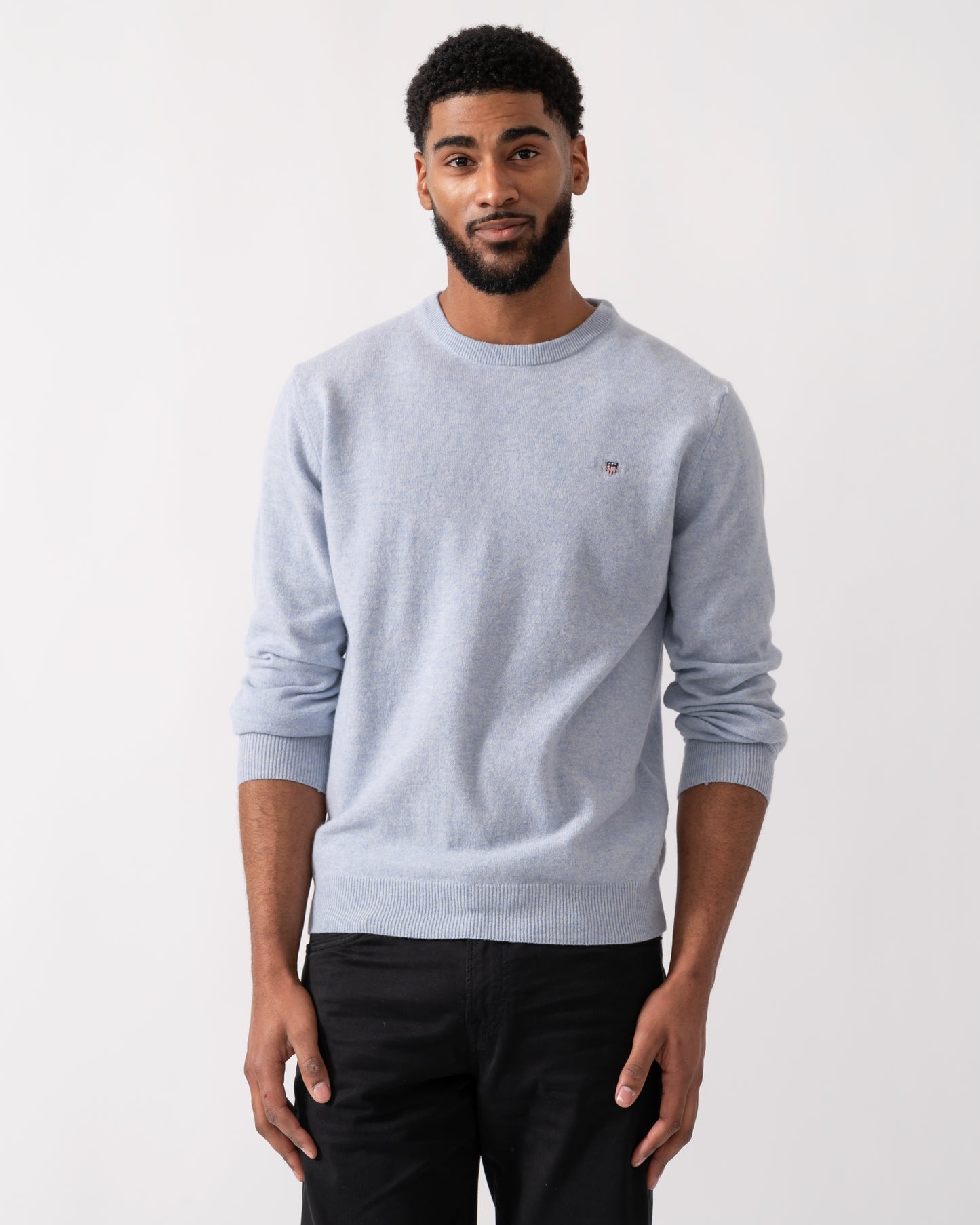 Model wearing a GANT Mens Superfine Lambswool Crew Neck Jumper in Ice Blue Melange