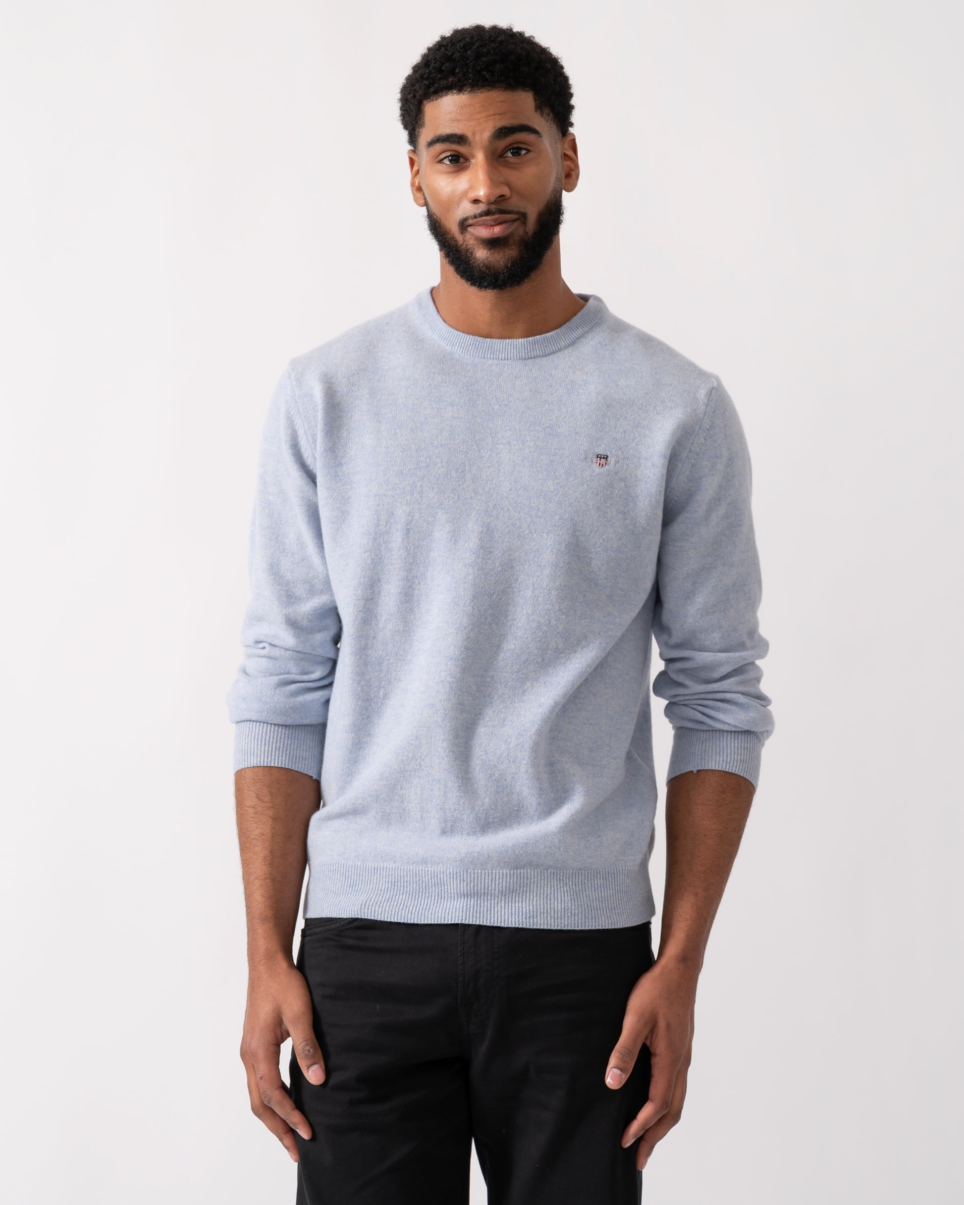 Model wearing a GANT Mens Superfine Lambswool Crew Neck Jumper in Ice Blue Melange