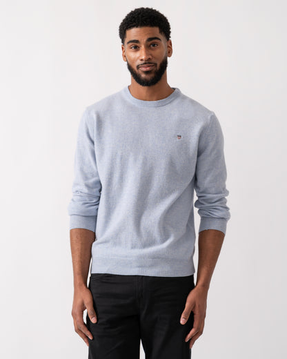 Model wearing a GANT Mens Superfine Lambswool Crew Neck Jumper in Ice Blue Melange