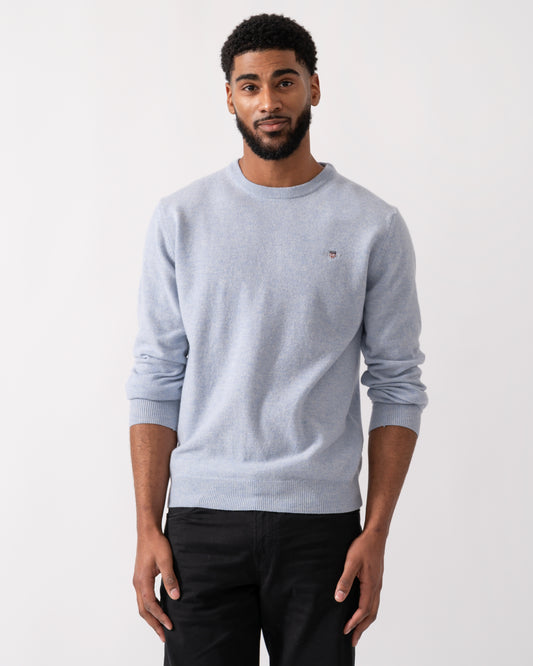 Model wearing a GANT Mens Superfine Lambswool Crew Neck Jumper in Ice Blue Melange