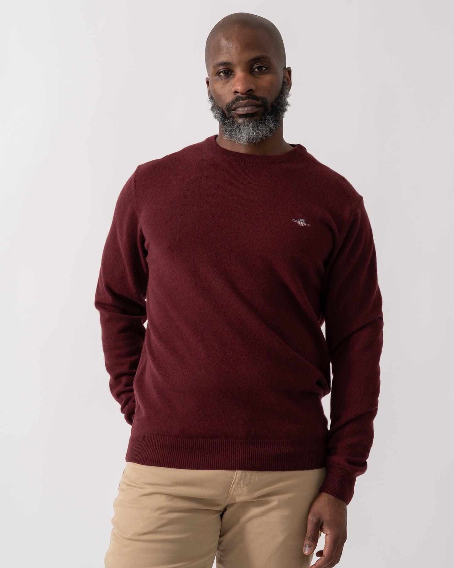 Model wearing a GANT Mens Superfine Lambswool Crew Neck Jumper in Bordeaux Melange