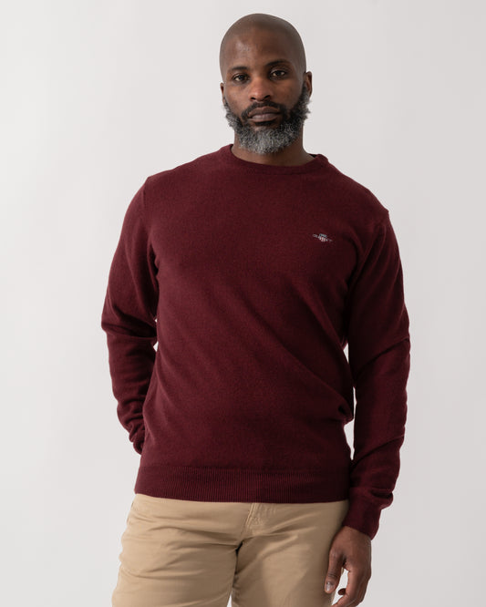 Model wearing a GANT Mens Superfine Lambswool Crew Neck Jumper in Bordeaux Melange
