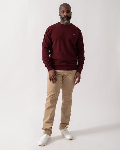 Full length shot of a Model wearing a GANT Mens Superfine Lambswool Crew Neck Jumper in Bordeaux Melange