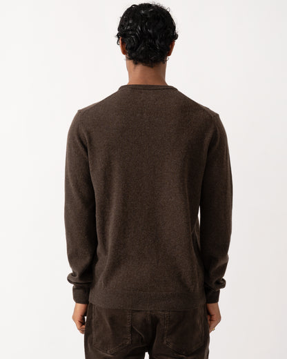 Studio photographshow the back of a model wearing a GANT Mens Superfine Lambswool Crew Neck Sweater in 280 Dark Brown Melange