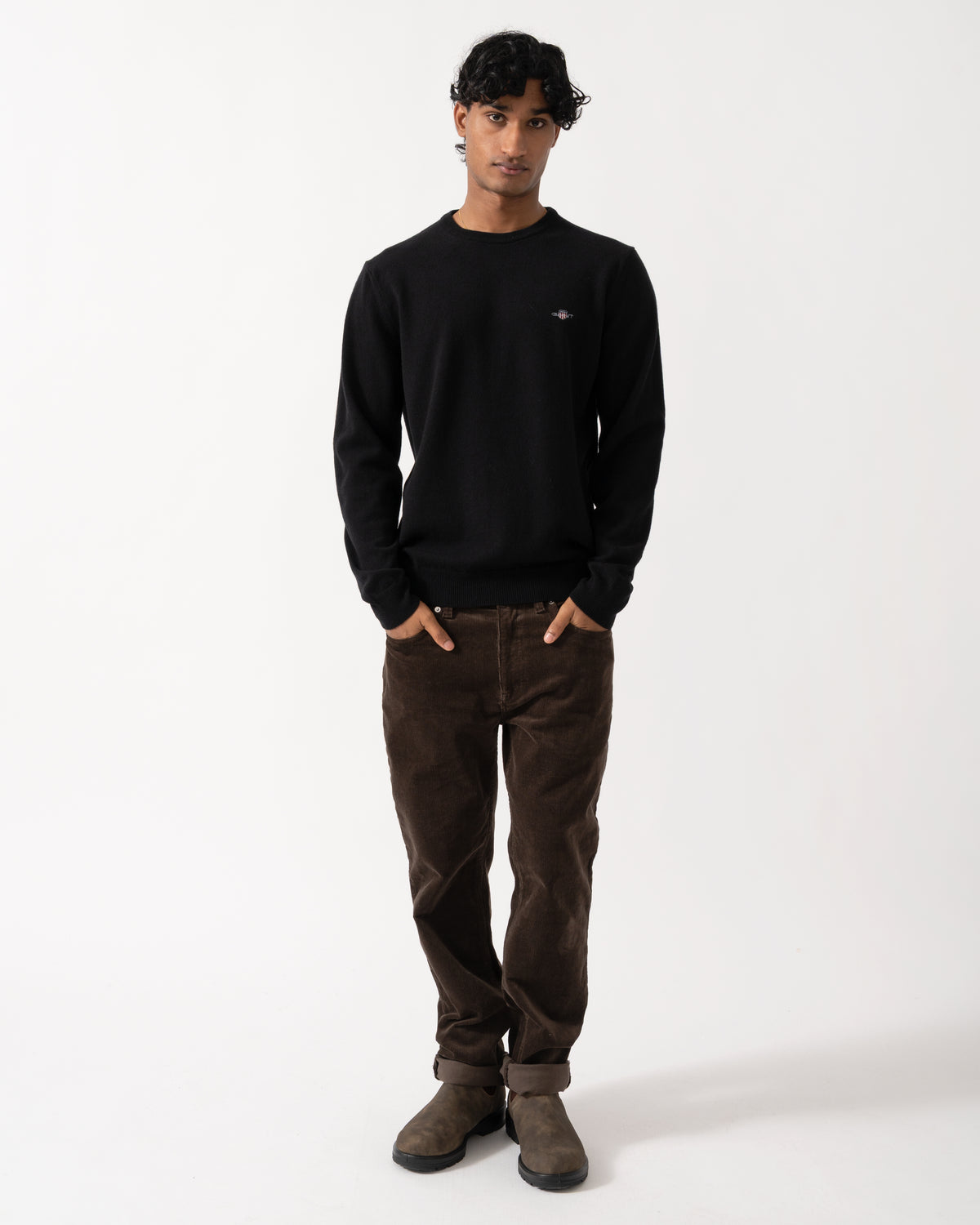 full length Studio photograph of a model wearing a GANT Mens Superfine Lambswool Crew Neck Sweater in 5 Black