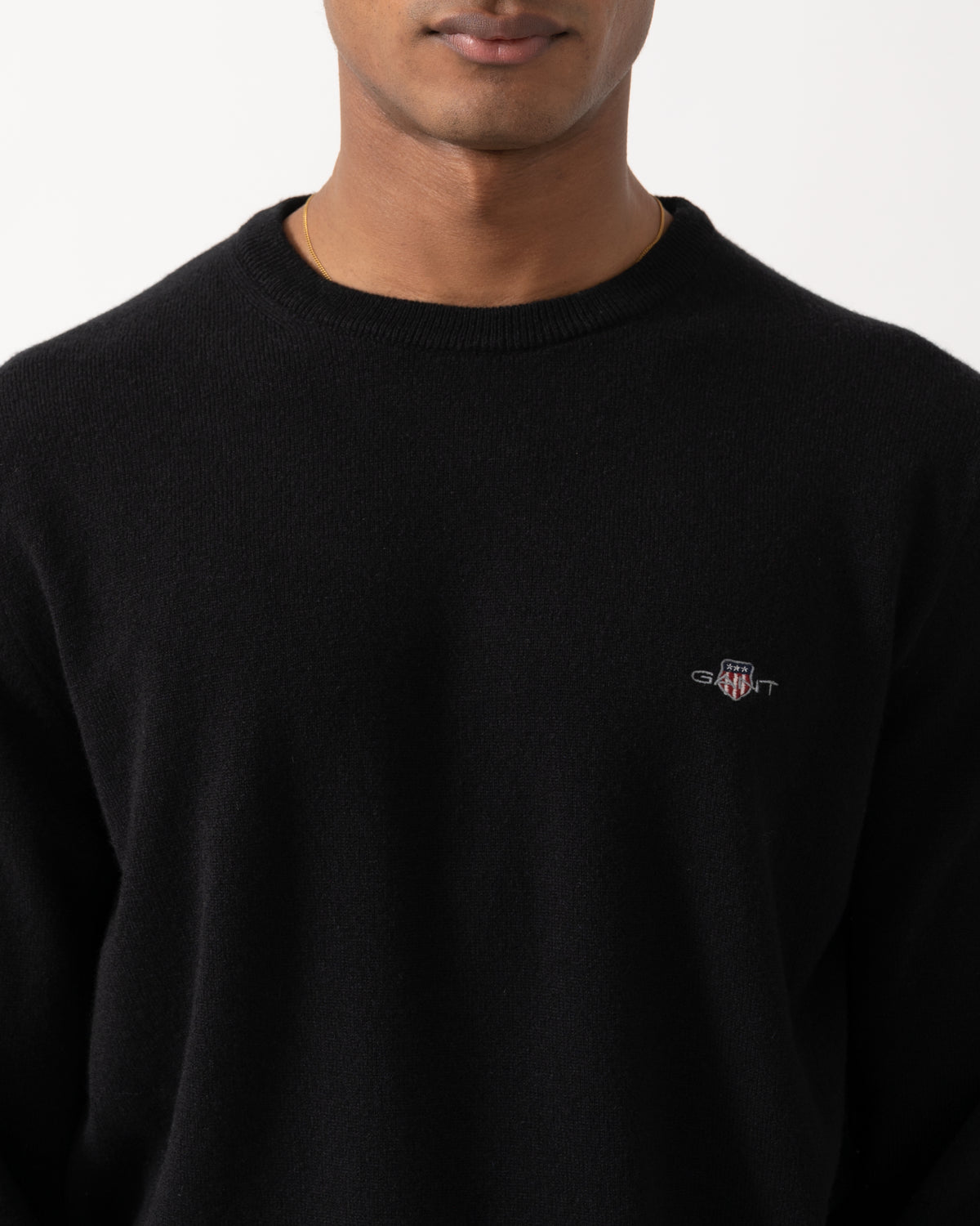 close up Studio photograph of a model wearing a GANT Mens Superfine Lambswool Crew Neck Sweater in 5 Black