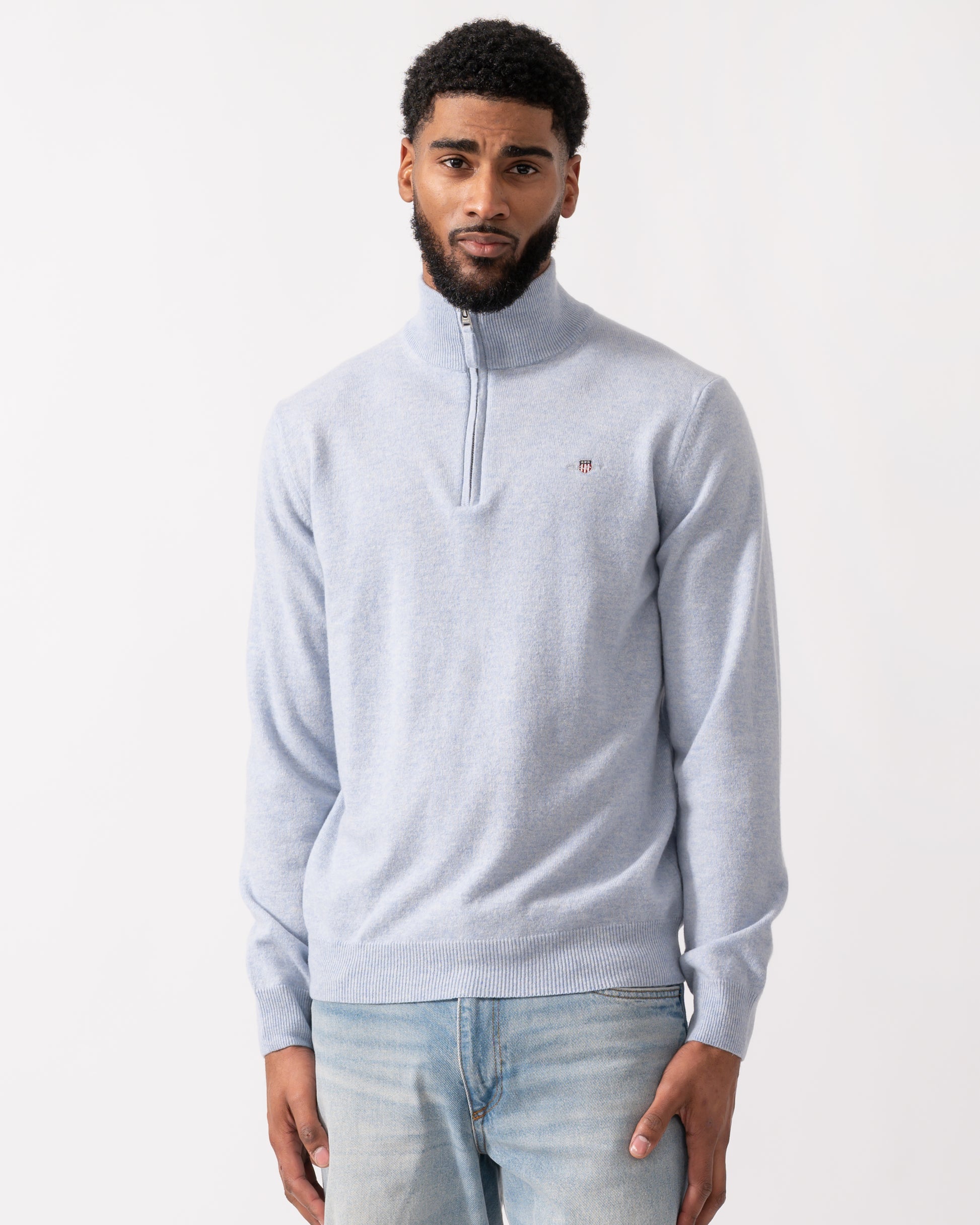 model wearing a GANT Mens Superfine Lambswool Half Zip Cardigan in Ice Blue Melange