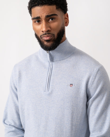 close up of a model wearing a GANT Mens Superfine Lambswool Half Zip Cardigan in Ice Blue Melange