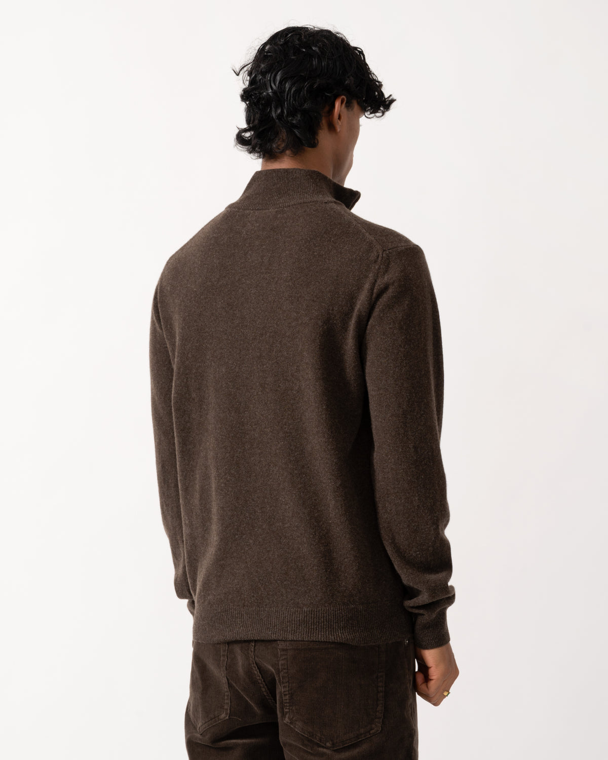 studio photograph showing the back of a model wearing a GANT Mens Superfine Lambswool Half Zip Sweater in 280 Dark Brown Melange