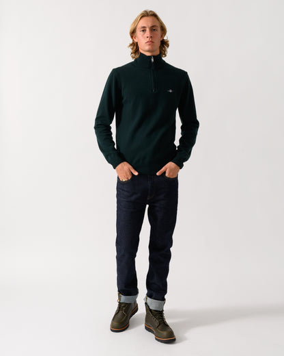 full length of a model wearing a GANT Mens Superfine Lambswool Half Zip Sweater in 374 Tartan Green