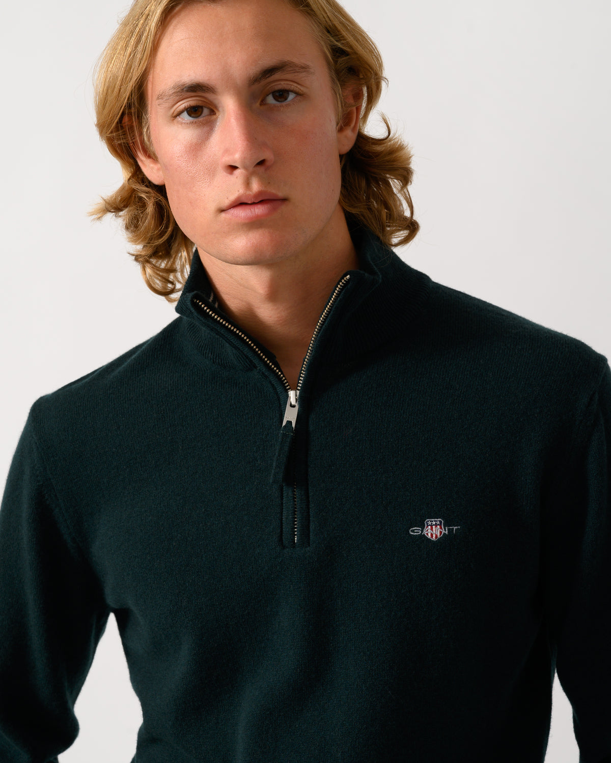 close up of model wearing a GANT Mens Superfine Lambswool Half Zip Sweater in 374 Tartan Green