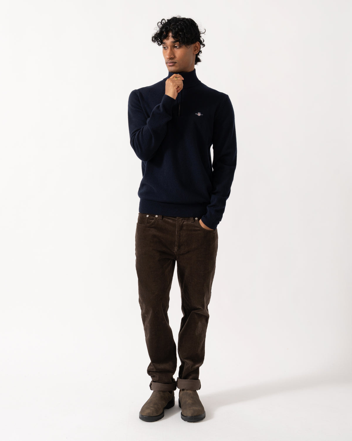 full length studio photograph showing a model wearing a GANT Mens Superfine Lambswool Half Zip Sweater in 410 Marine