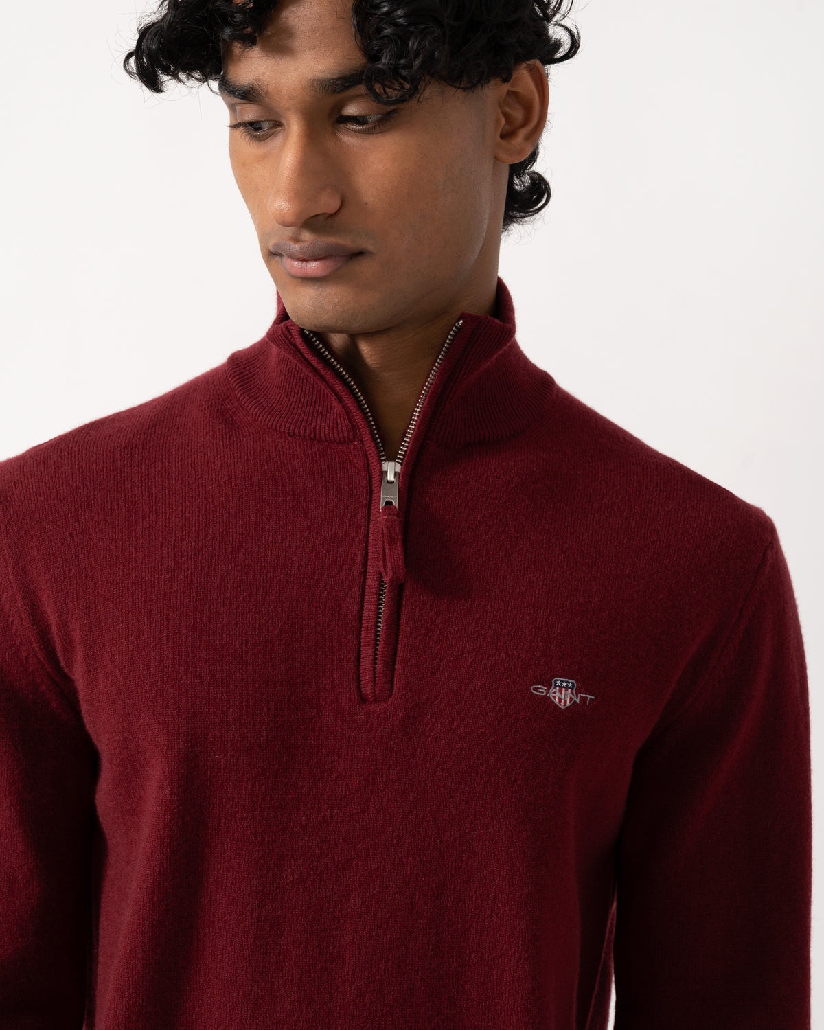close up Studio photograph of a model wearing a GANT Mens Superfine Lambswool Half Zip Sweater in 604 Plumped Red