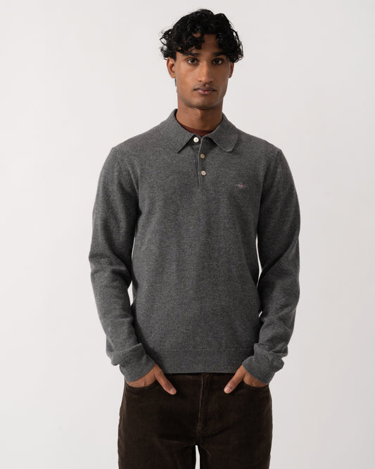 Studio photograph of a model wearing a GANT Mens Superfine Lambswool Long Sleeve Polo in 90 Charcoal Melange