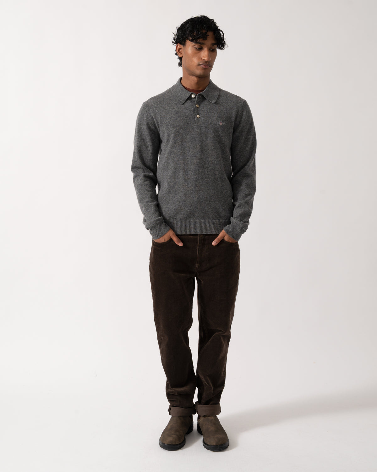 full length Studio photograph of a model wearing a GANT Mens Superfine Lambswool Long Sleeve Polo in 90 Charcoal Melange