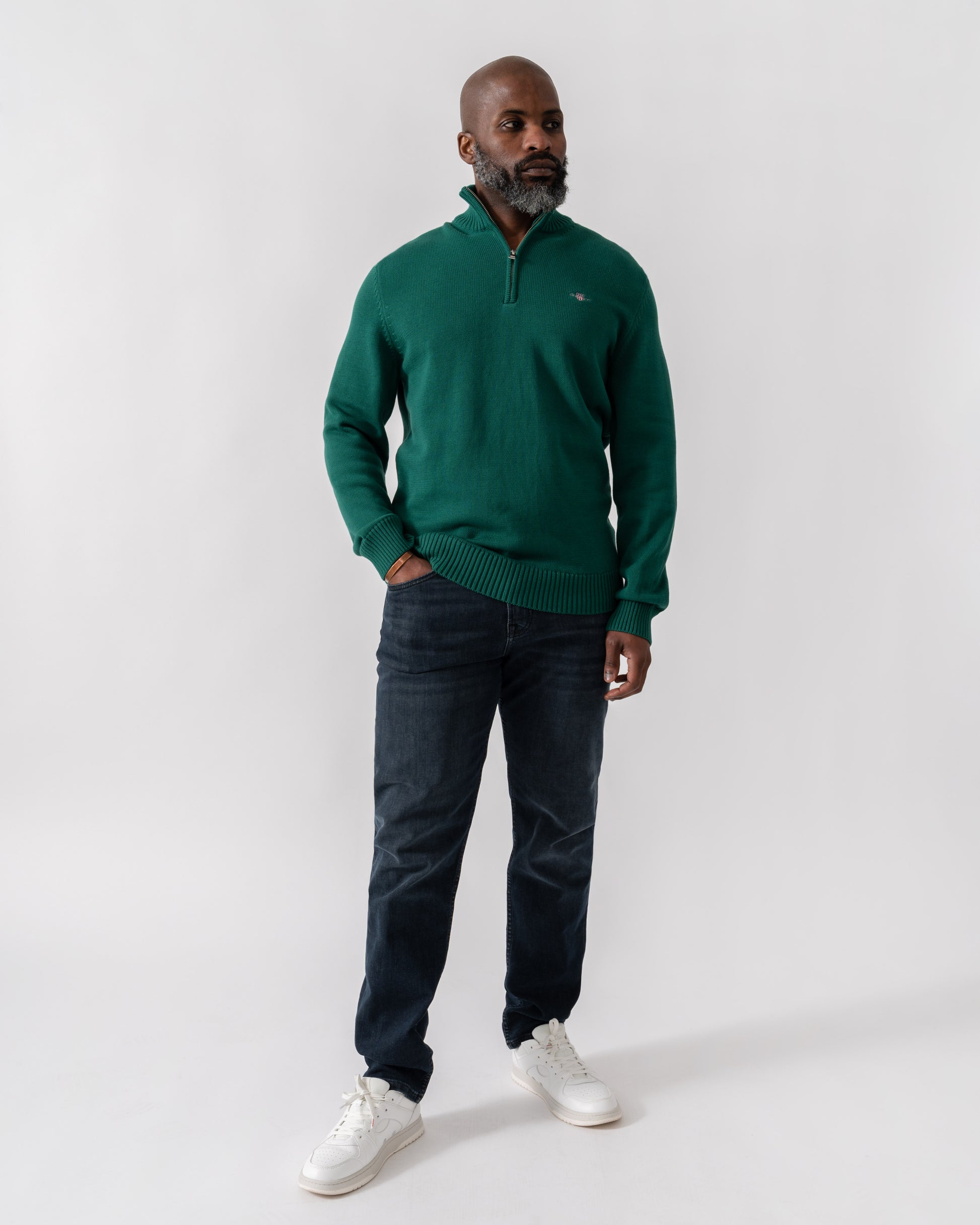 Model wearing GANT Mens Casual Cotton Half Zip Jumper in 373 Deep Forest Green - Full length