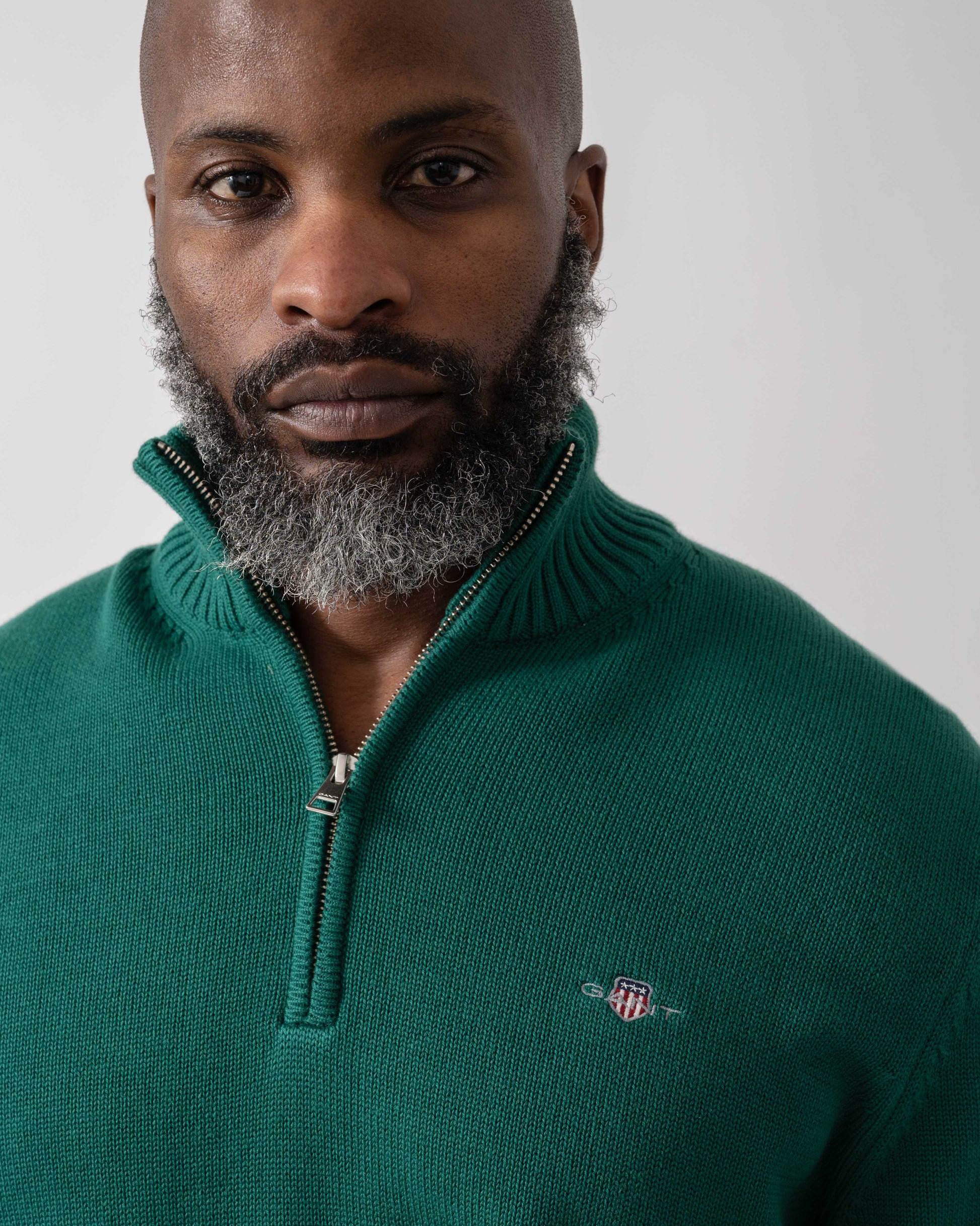 Model wearing GANT Mens Casual Cotton Half Zip Jumper in 373 Deep Forest Green - Detail