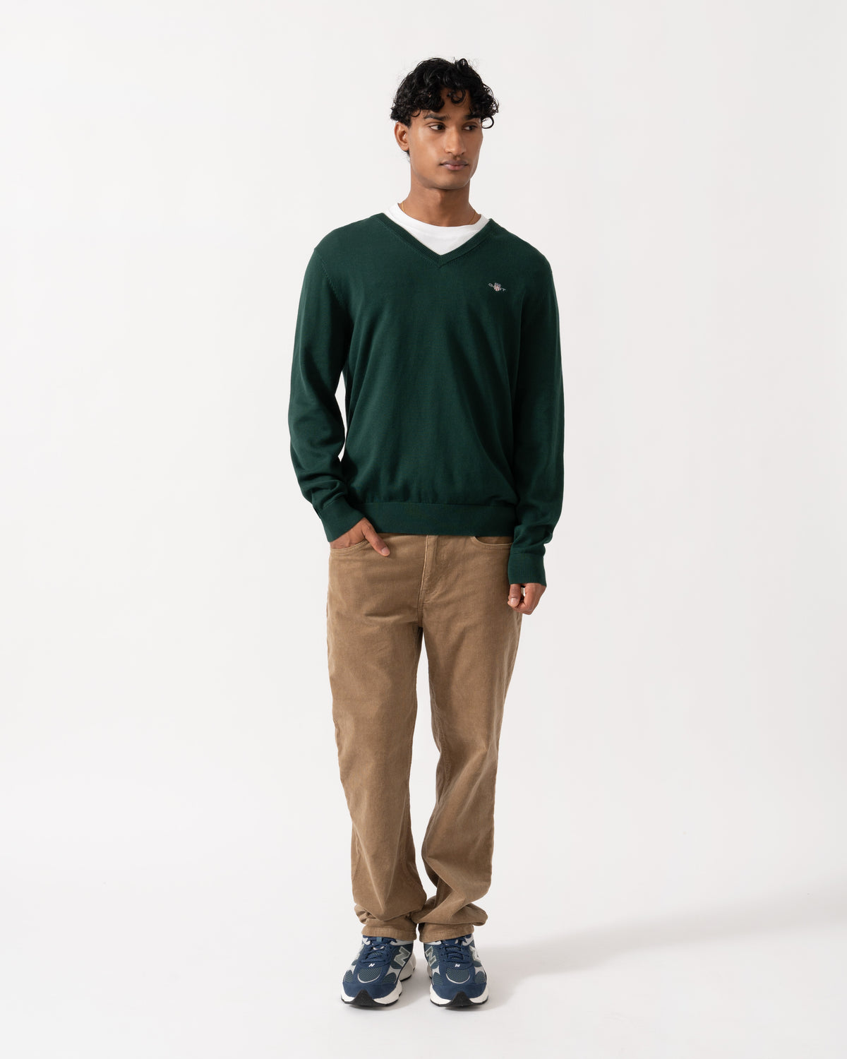 Model wearing the GANT Mens Classic Cotton Shield Logo V-Neck Jumper - 374 Tartan Green