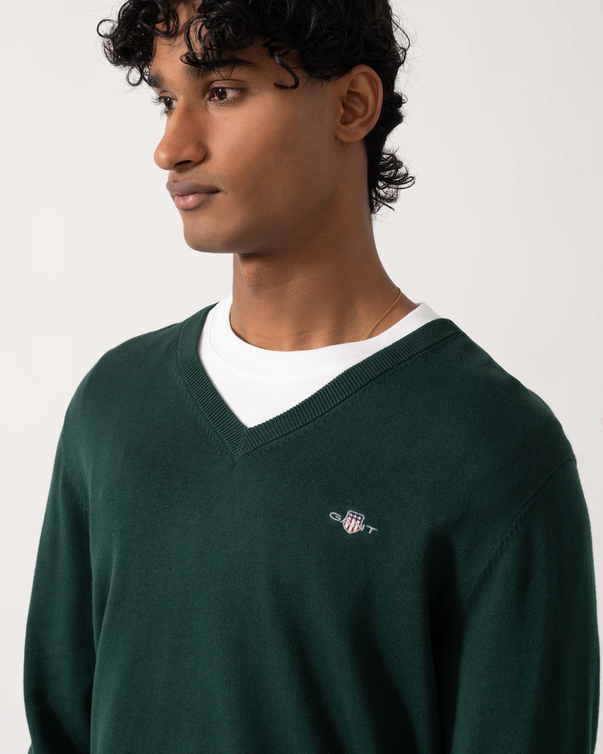 Close up of the GANT Mens Classic Cotton Shield Logo V-Neck Jumper - 374 Tartan Green