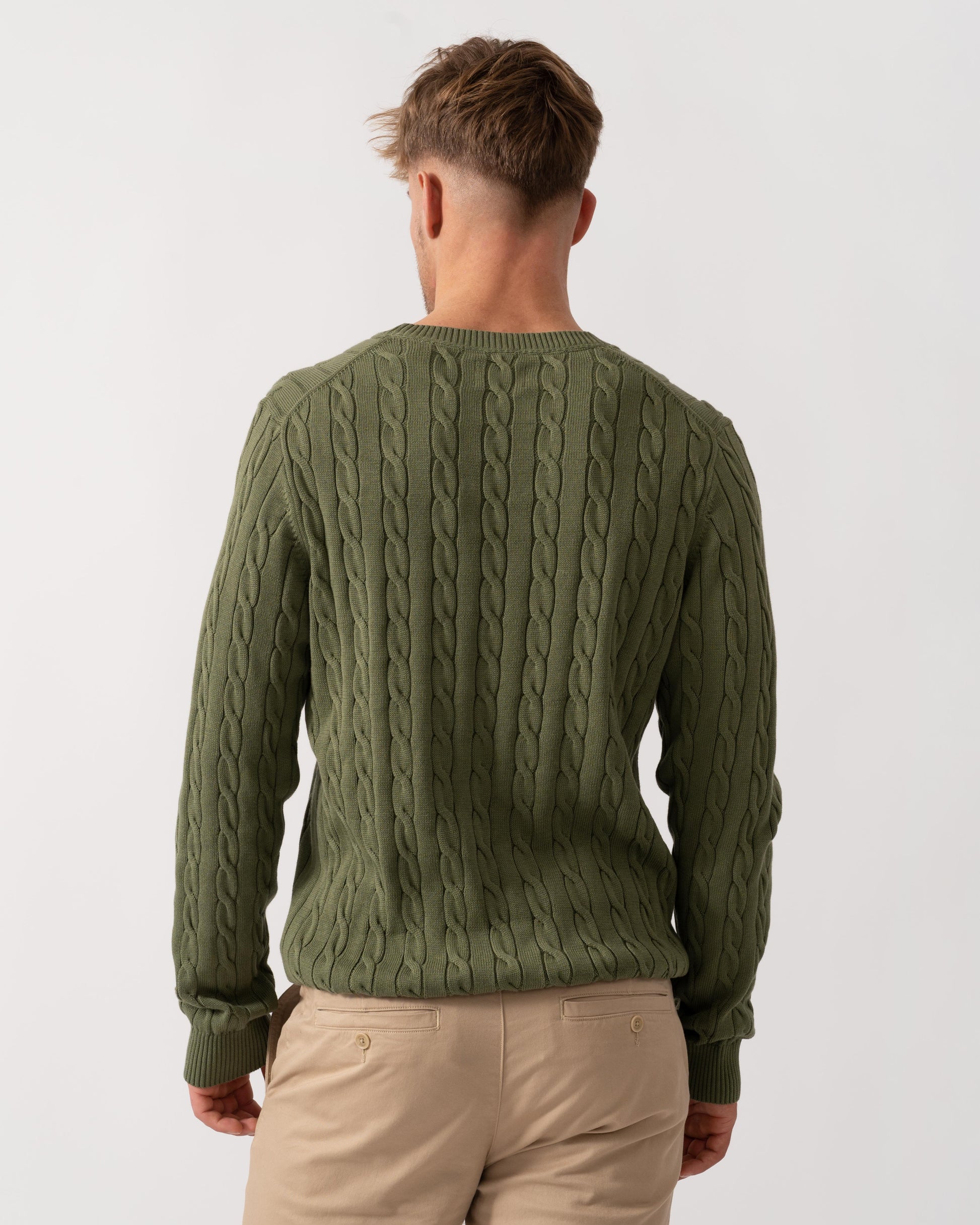 Model wearing GANT Mens Cotton Cable Knit Crew Neck Jumper in 379 Dry Herb Green - Back