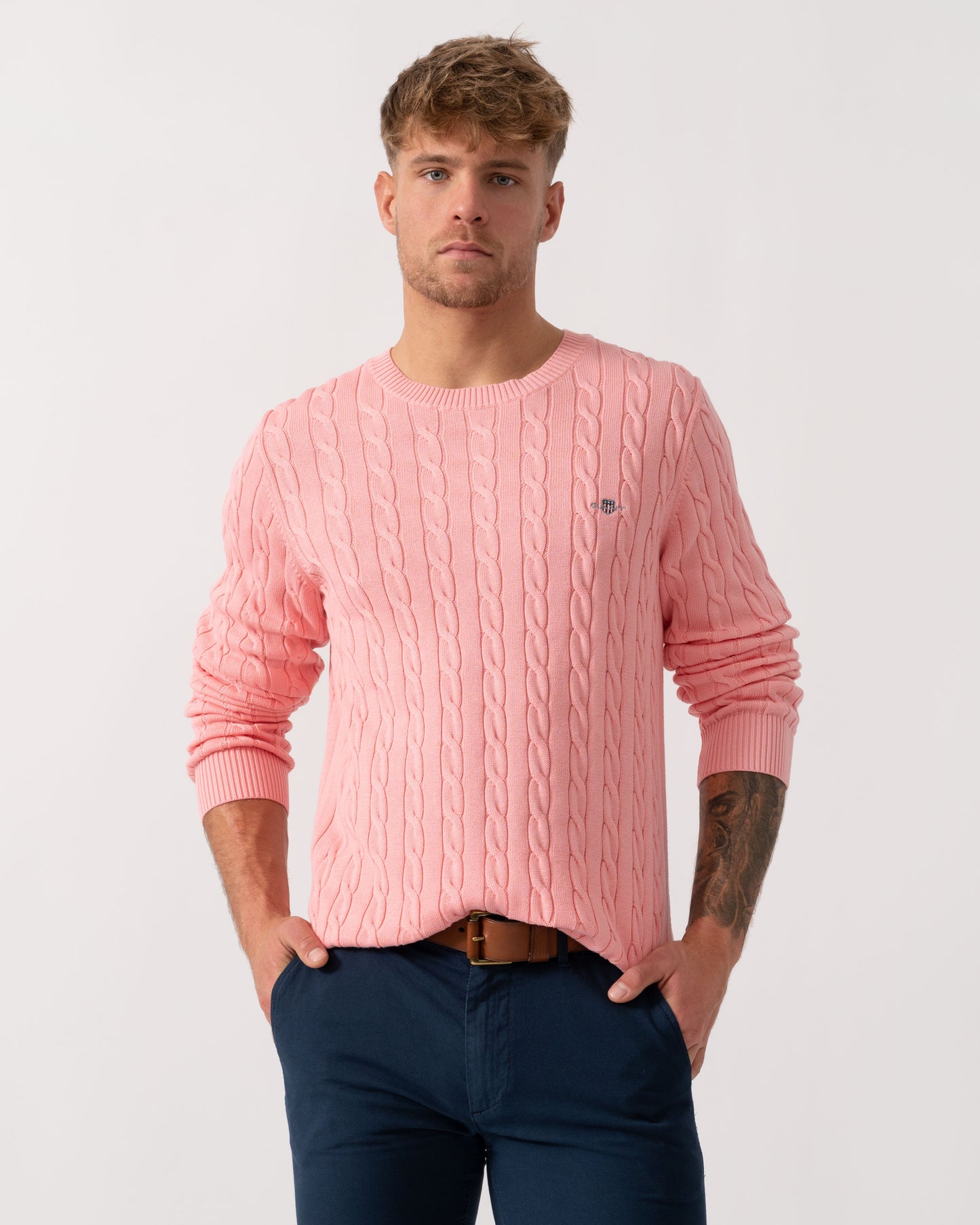 Man wearing GANT Mens Cotton Cable Knit Crew Neck Jumper in 666 Washed Pink - Main