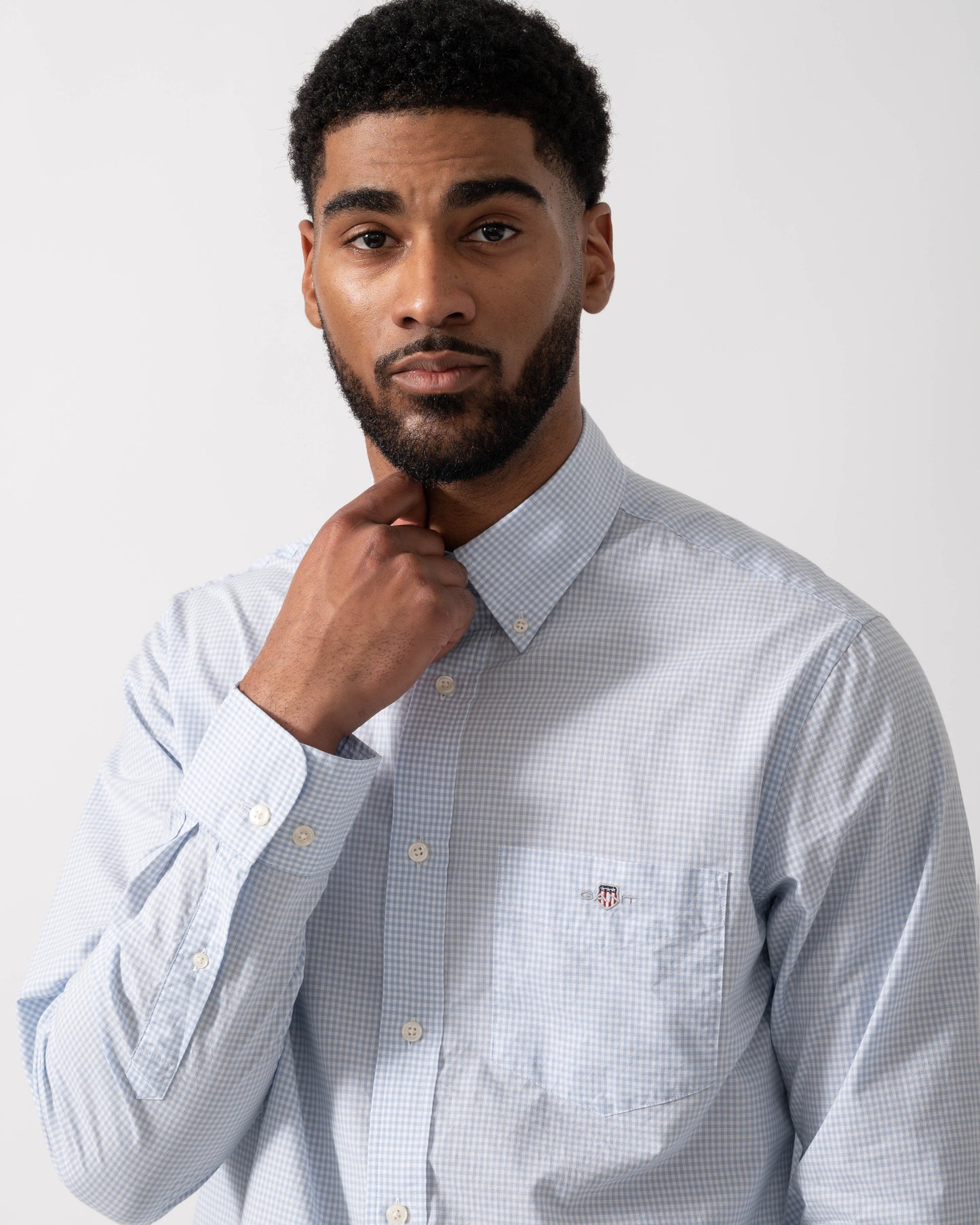 Model wearing GANT Mens Regular Fit Classic Poplin Gingham Shirt in 455 Light Blue - detail