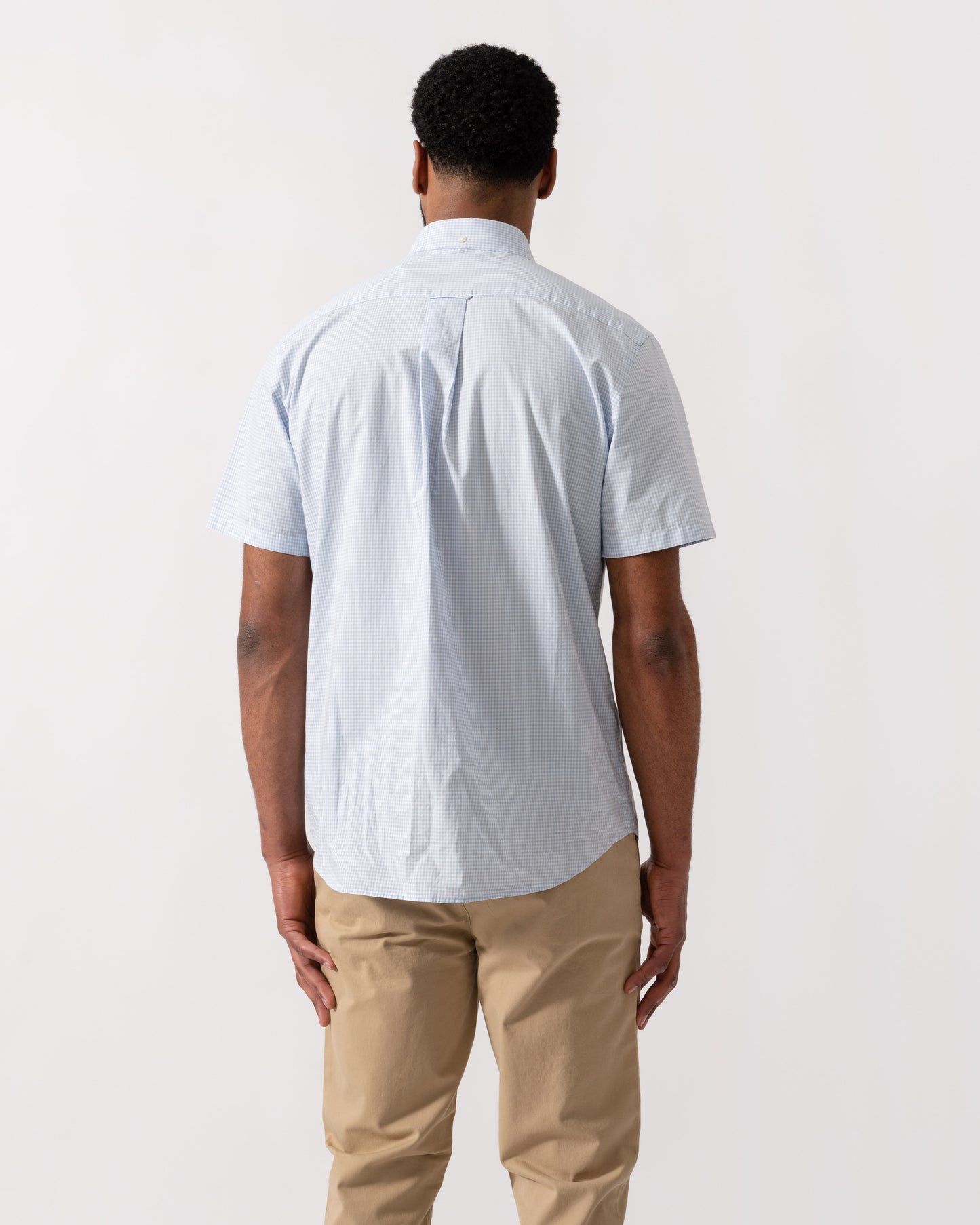 Model wearing a GANT Mens Regular Fit Classic Poplin Gingham Short Sleeve Shirt in 455 Light Blue - back
