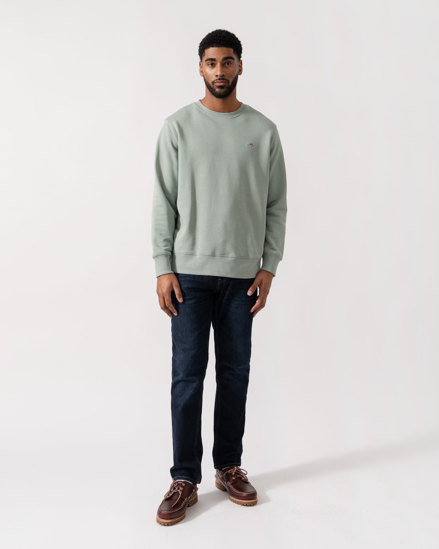 Model wearing GANT Mens Regular Fit Shield Logo Crew Neck Sweatshirt -in 10 Ceramic Grey -  full length