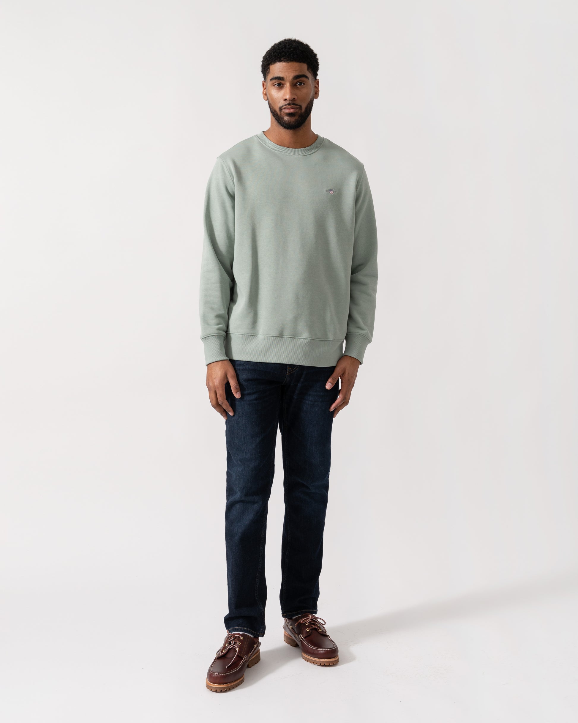 Model wearing GANT Mens Regular Fit Shield Logo Crew Neck Sweatshirt -in 10 Ceramic Grey -  full length