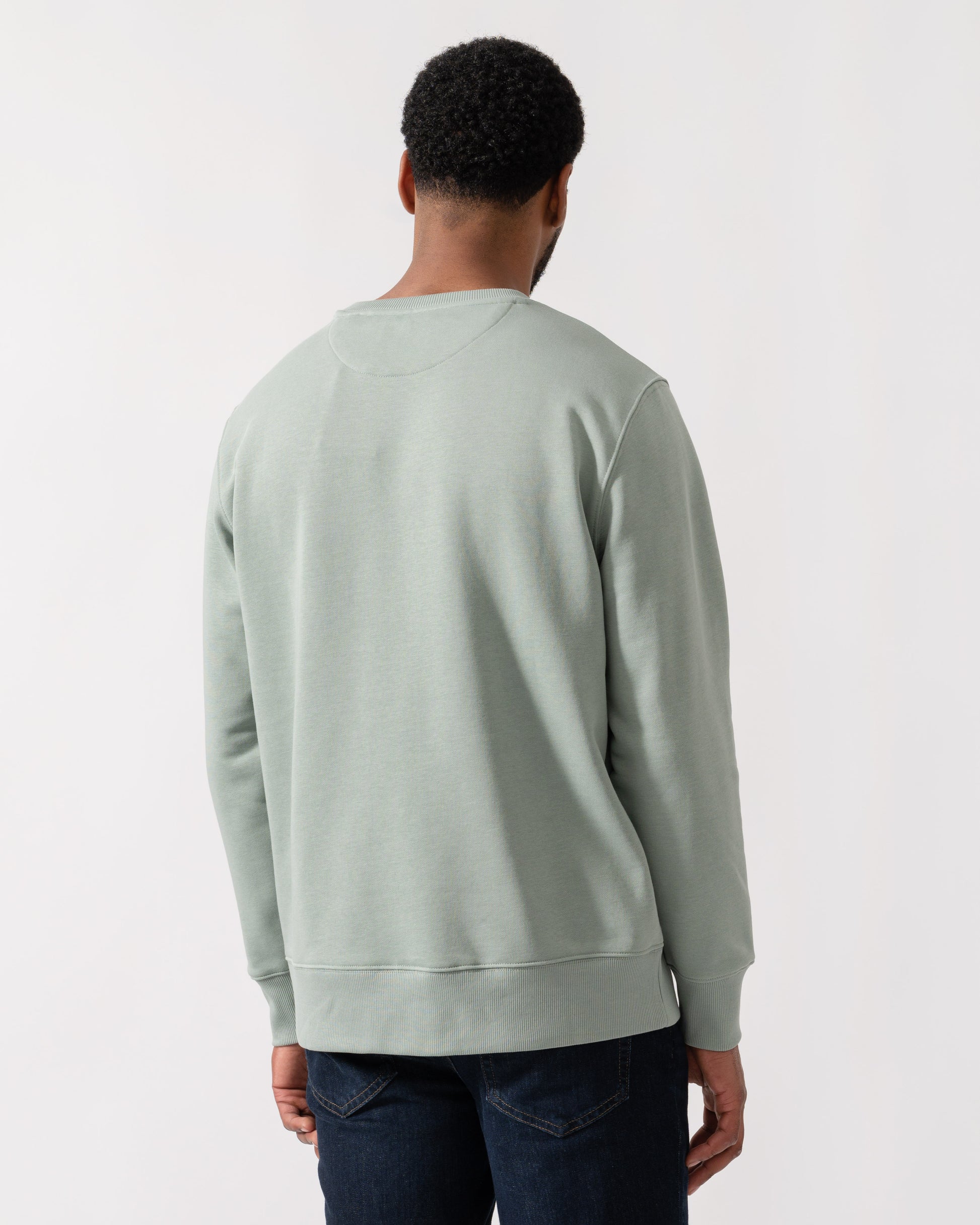 Model wearing GANT Mens Regular Fit Shield Logo Crew Neck Sweatshirt -in 10 Ceramic Grey - back